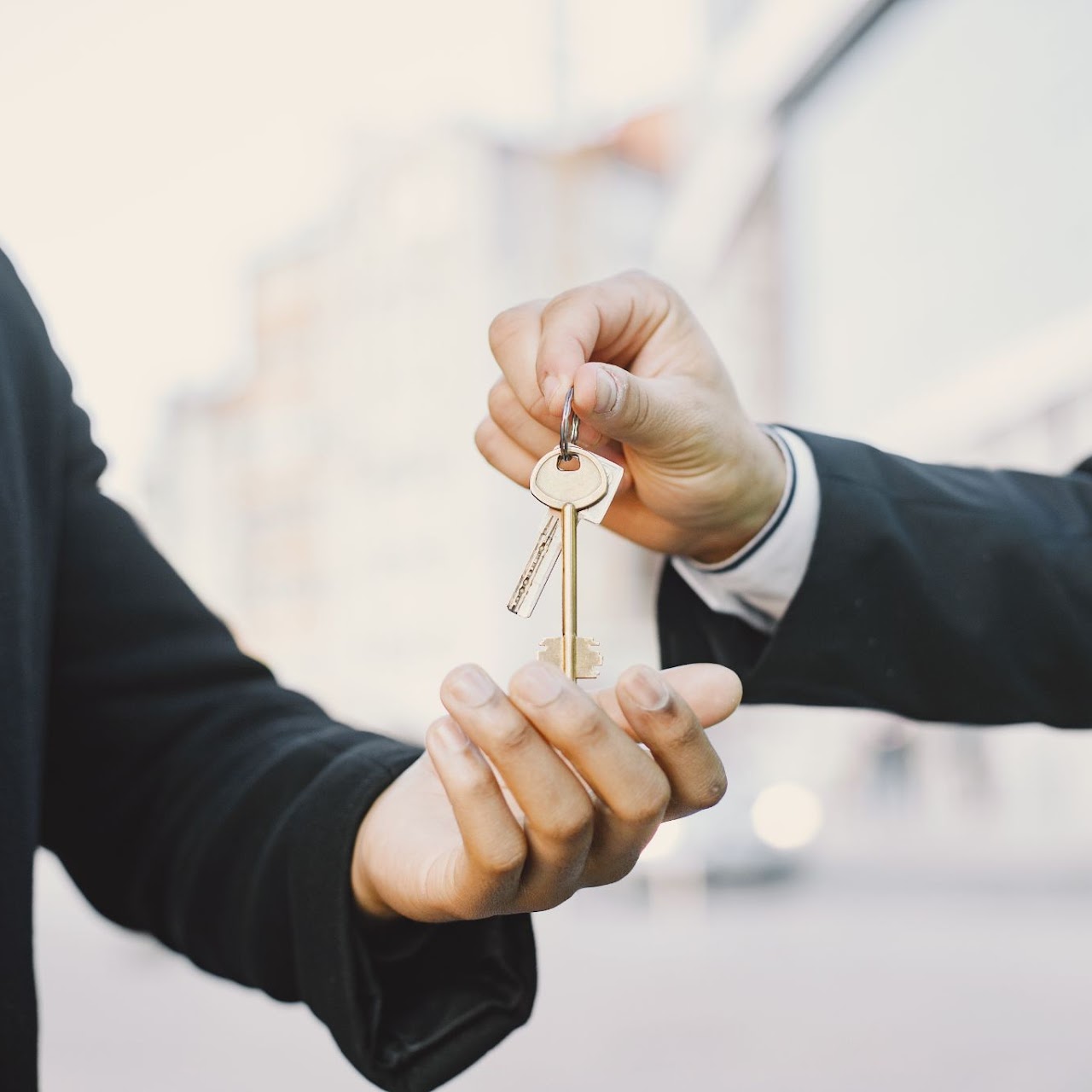 buying-property-concept-man-uniform-giving-keys-black-man